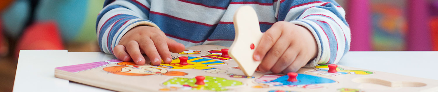 toddler working on a puzzle